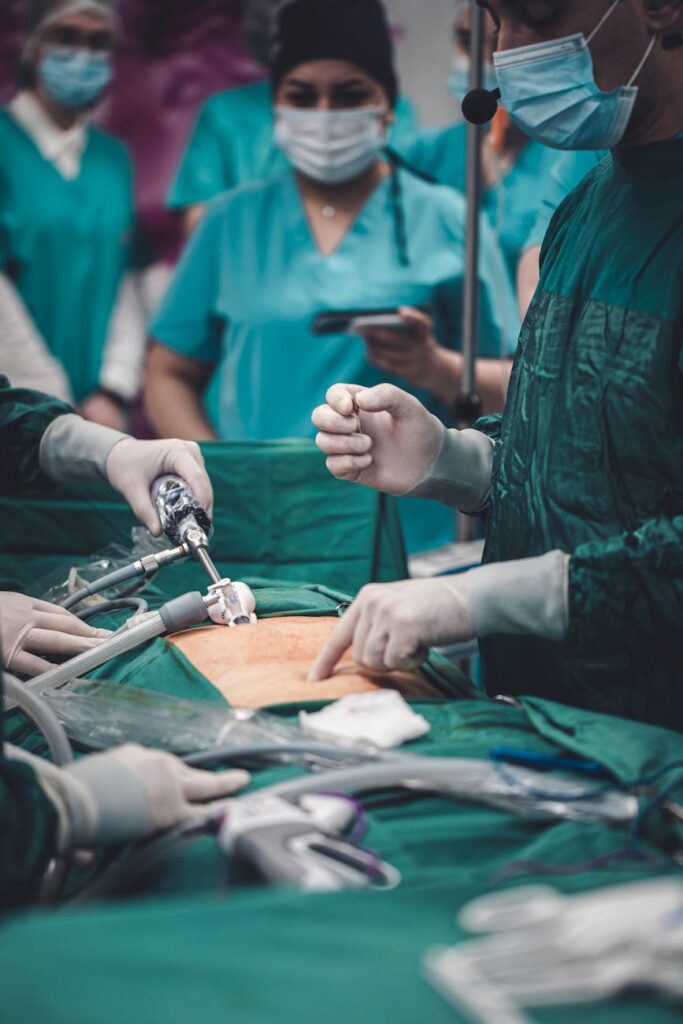 Medical professionals conducting surgery with advanced equipment in an operating room setting.